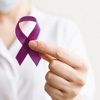 Female Doctor In White Coat Holds Purple Ribbon