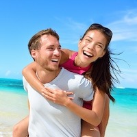 Caucasian couple smiling on beach